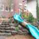 preschool natural playground boulders and slide