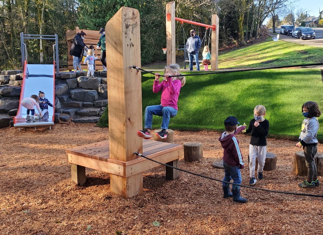 Nature-integrated playground in a public park, co-created with the community to support imaginative, inclusive play for all children. log and rope climber